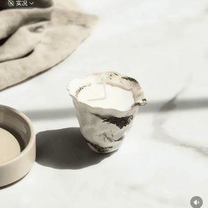 Clay pot cup with a textured design on a light surface